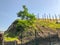 A beautiful view of the hillock with green grass against the sky, construction of a new building, a house frame, fittings