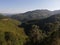 Beautiful view of hills and valleys. Preserved nature environment. Pamorama of green hills, valleys and forests with blue sky.