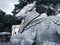 Beautiful view of huge white Nandi or Basava Stone Statue in Chamundi Betta. Sculpture design carving with bell and ornaments of