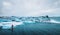 Beautiful view of icebergs glacier lagoon with a guy paddle boarding sup