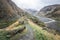 Beautiful view on impressive gorge in Caucasus mountains. Monument in form of Cross and path to it