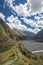 Beautiful view on impressive gorge in Caucasus mountains. Monument in form of Cross and path to it