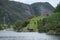 Beautiful view of the lake with green rocky mountains. Naeroyfjord, Norway.