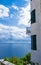 Beautiful view of the lighthouse on the sea. Beautiful coast of the Adriatic Sea. Blue sea white clouds.