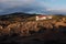 Beautiful view of a lonely building on a rocky crag with the mountains in the background