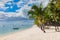 Beautiful view of luxury beach in Mauritius. Transparent ocean with boats, beach, coconut palms and sky