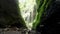 Beautiful view of Madakaripura waterfall with green moss and blue sky in Java, Indonesia