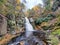 Beautiful view of the main waterfall surrounded by stunning fall foliage near Bushkill Falls, Pennsylvania, U.S