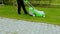 Beautiful view of male cutting grass on front yard lawn.