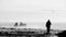 Beautiful view of a man walking in the beach with cliffs around