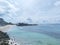 The beautiful view of the Melasti Ungasan beach in Bali with a wooden boat seen from afar