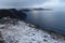 Beautiful view of misty snow-covered cliffs on a coast of Norway