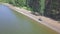 Beautiful view of motorcyclist driving on winding pass road. Clip. Top view of the motorcyclist in nature