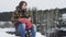 A beautiful view of the mountains in winter. A Young Man is Walking Up Mountain Slope. The handsome man is looking over