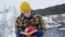 A beautiful view of the mountains in winter. A Young Man is Walking Up Mountain Slope. The handsome man is looking over