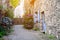 Beautiful view of narrow old street with historic traditional houses in old villge in Europe with blossom bushes of hydrangea