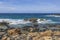 Beautiful view of nature. Stone shore washed by waves of Caribbean sea.