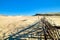 Beautiful view of nordic sand dunes and protective fences at Curonian spit, Nida, Klaipeda, Lithuania. Buried wood