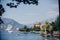 Beautiful view on old buildings and boats on lake in Stresa city, Italy. Architecture and shore on Lago Maggiore in sunny day on