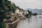 Beautiful view on old buildings and boats on lake in Stresa city, Italy. Architecture and shore on Lago Maggiore in sunny day on