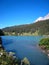 Beautiful view over a blue swiss lake with snow-covered mountains and flowers