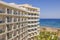 Beautiful view of part of hotel building with balconies on Mediterranean coast.