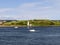 Beautiful view of the Peggys Point lighthouse and yachts on a bay on a summer day