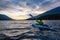 Beautiful View of Person Kayaking on Scenic Lake at Sunset