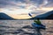 Beautiful View of Person Kayaking on Scenic Lake at Sunset