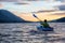 Beautiful View of Person Kayaking on Scenic Lake at Sunset