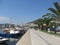 Beautiful view of the promenade of Kavala, where tourists and townspeople walk, surrounded by palm trees and parked pleasure boats