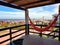 Beautiful view of Punta del Diablo, Rocha, Uruguay. Orange Paraguayan hammock on the balcony overlooking the beach. Relaxing vacat