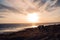 Beautiful view of a quiet bench on a sandy beach at sunset in Porthcawl