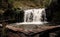 Beautiful view of raging waterfall with a wooden pathway