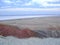 Beautiful view of the red mountain. Natural elevation in the steppe. Panorama of salt lake.