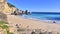 Beautiful view of Ribeiro do Cavalo Beach with rock formations in the sea in Portugal