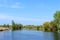 Beautiful view of the river and blue sky. Summer landscape. Place to relax, picnic.