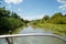 Beautiful view on river and green nature with blue sky from motor boat seat