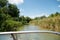 Beautiful view on river and green nature with blue sky from the motor boat seat.