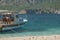 Beautiful view of rocky cliff and yacht on the seashore.