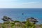 Beautiful view of the rocky shore of Elba Island, blue sea and boats. Elba island, Italy