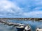 Beautiful view of the rows of fishing boats on the river gleaming under the cloudy sky