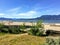 A beautiful view of the sandy beaches of Spanish Banks, with tankers and mountains in the background on a beautiful sunny day.