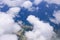 Beautiful view of the sea and the coast of the island of San Miguel from the porthole of the plane. White clouds over the atlantic