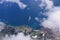 Beautiful view of the sea and the coast of the island of San Miguel from the porthole of the plane. White clouds over the atlantic