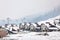 Beautiful view of ski resort with many cottages on snowy day. Winter