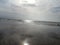 Beautiful view of sky and beach with amazing clouds with sunlight falling on clouds and a man lying in one corner