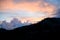 Beautiful view on sky and clouds at sunrise. Dark silhouettes of mountains at dawn.