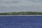 A beautiful view of a small Atoll in the middle of the south Pacific Ocean from the cruise ship deck while the officers and the