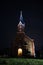 Beautiful view of small lovely local church in late evening with iluminated lights